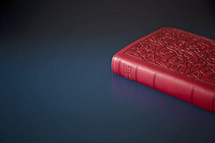 red Bible on a table 