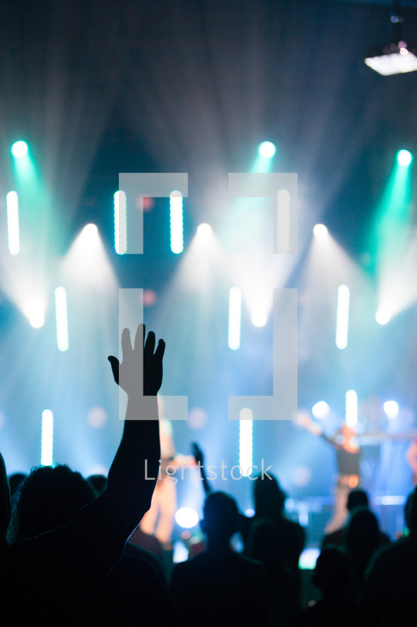 hands raised in worship at a christian rock concert 
