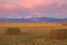 hay bales with distant snow capped mountains 