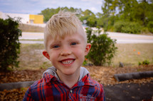 A smiling blonde boy.