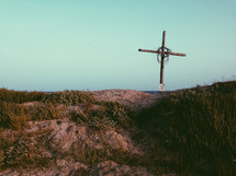 a cross on a hill outdoors 