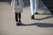 mother and daughter walking to school 