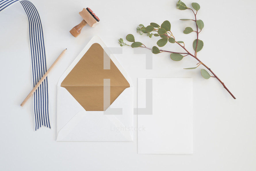 white background, striped, ribbon, blank, white, notecards, paper, desk, eucalyptus, twig, stamps, envelope