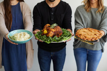 people holding thanksgiving food 