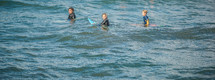 teens on surfboards in the ocean 