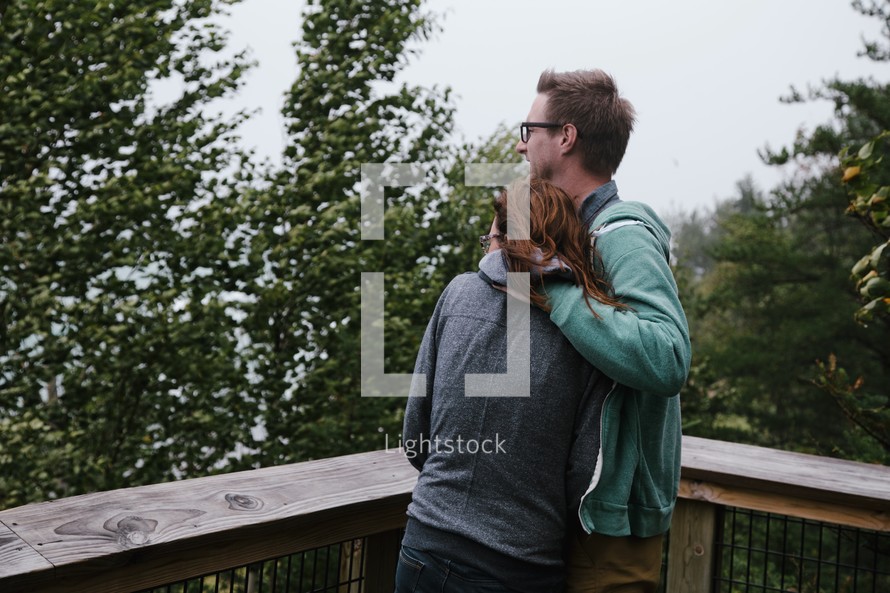 couple hugging on a balcony 