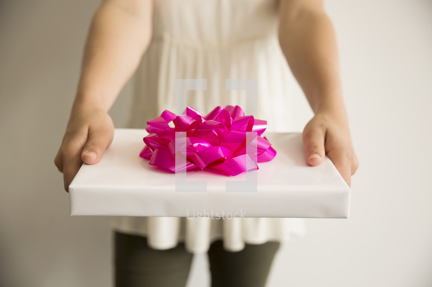 woman holding a wrapped gift 
