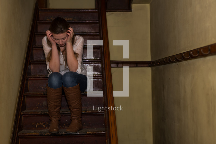 frustrated teen girl sitting on stairs 