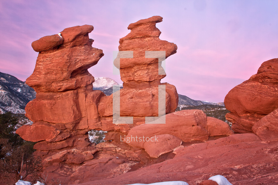 The Siamese Twins rock formation at Garden of the Gods. Pikes Peak can be seen  between the formations