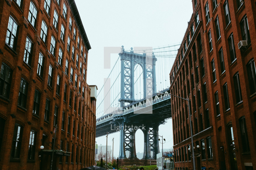 brick buildings and view of a bridge in NYC 
