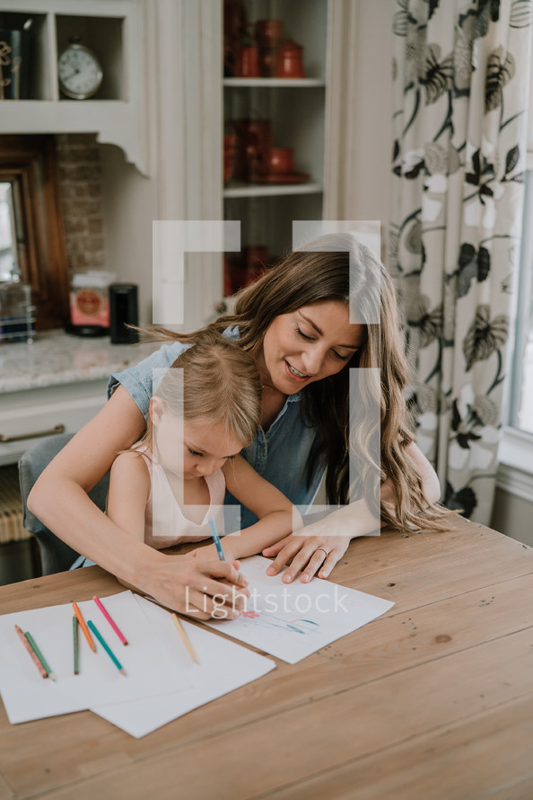 a mother coloring with her daughter 