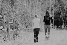 Two women walking in the countryside.