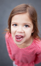 girl child sticking her tongue out 