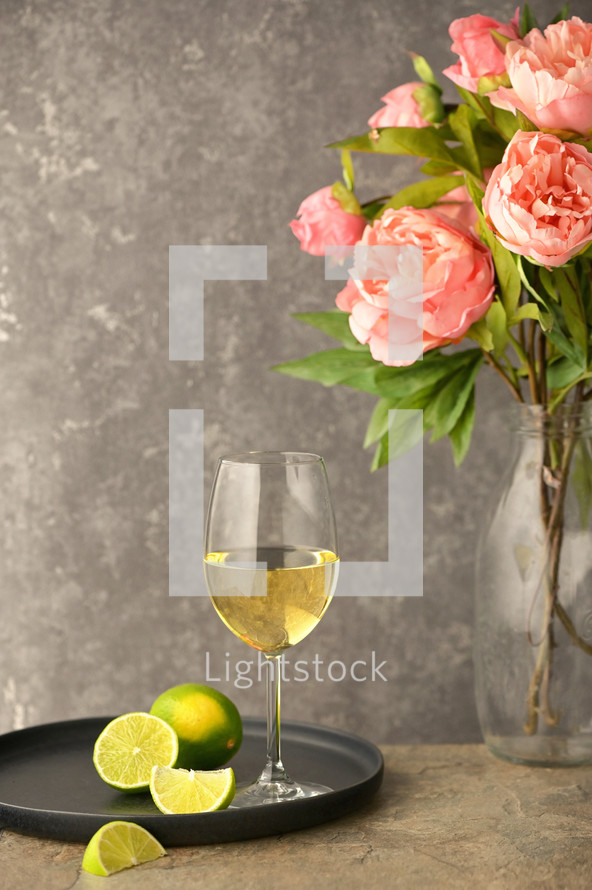 Glass Of White Wine and Peony Flowers