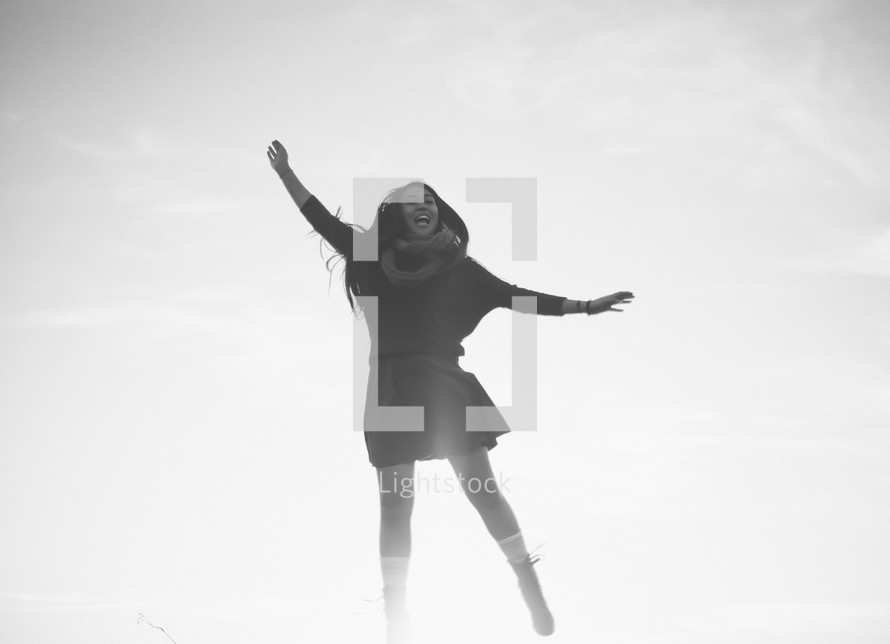 A young woman jumping in the air. 
