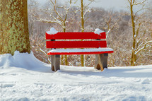 snow on a red bench 