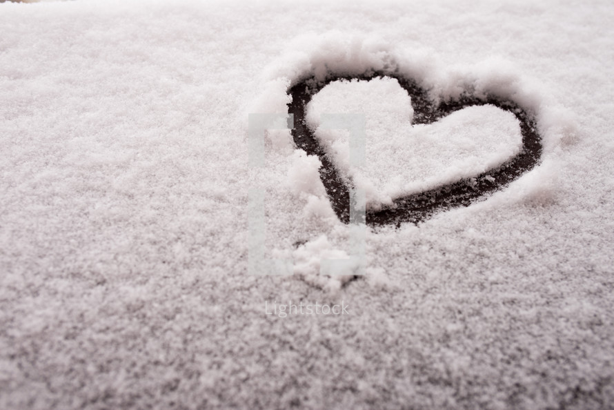 Hand drawn heart in the frozen snow