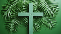 Green cross laid on green palm leaves. 