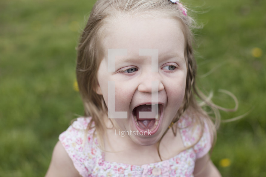 toddler girl outdoors yelling 
