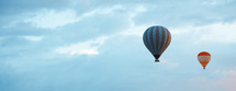 Two hot air balloons in blue sky with empty space. Horizontal photo