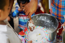 serving rice to hungry children 