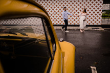expecting couple portrait with Yellow car 