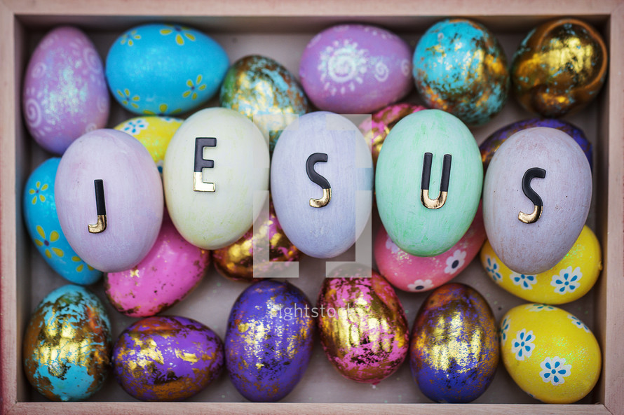 word Jesus on pastel Easter eggs