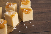 Sea Salt and Caramel Fudge on a Wooden Table with Baking Paper