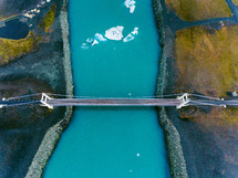 bridge over a river with icebergs 