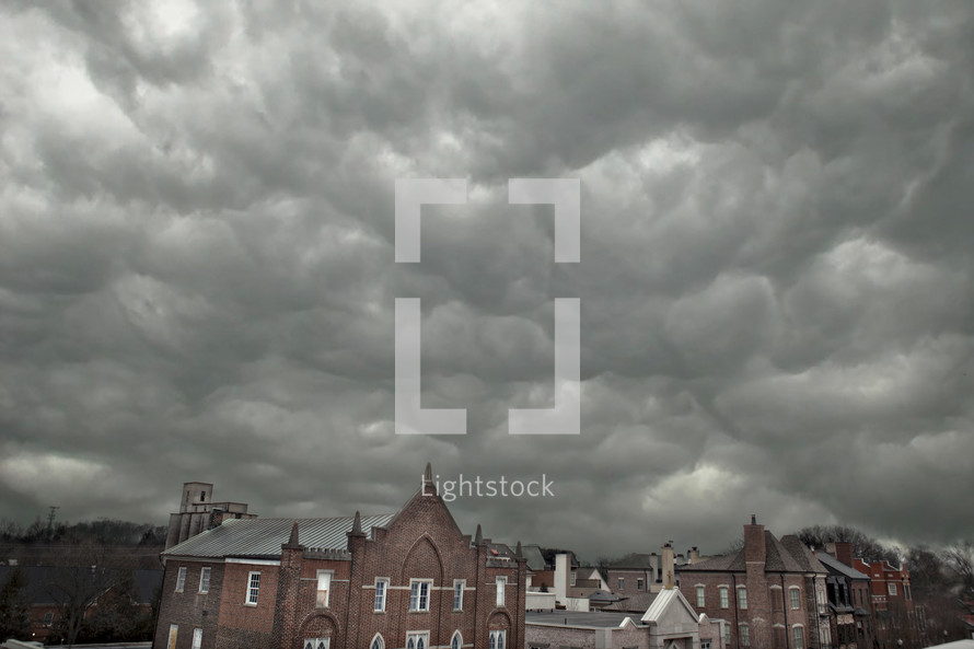 storm clouds over a brick church 
