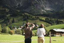 couple taking a picture of a mountain and valley