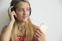 a teen girl listening to music with headphones 