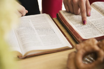 pointing at scripture at a Bible study 