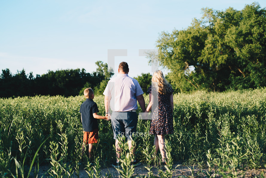a family walking through field of crops 