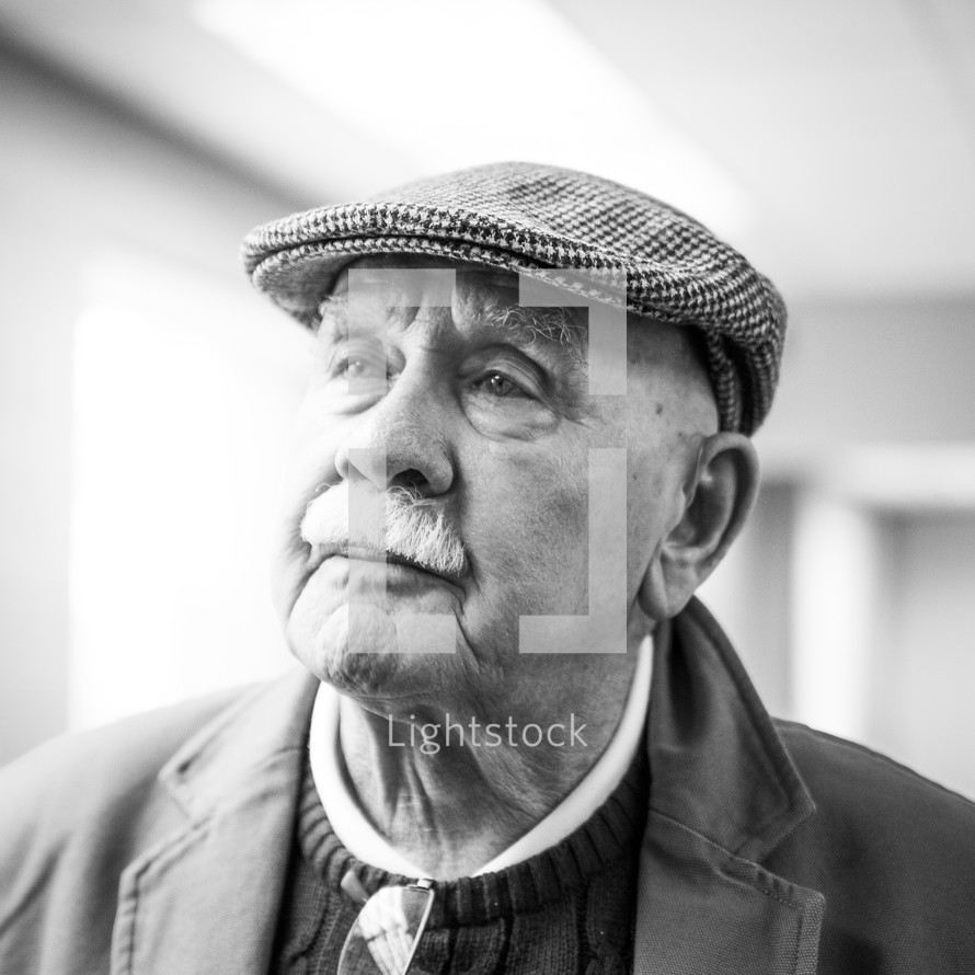 headshot of an elderly man in a hat 