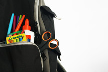 school supplies in a book bag 