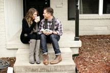 couple drinking coffee on their front porch 