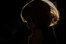 a little girl with sunlight in her hair 