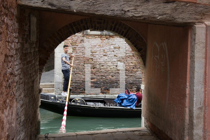 man paddling a gondola 