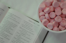 bowl of candy and open Bible 