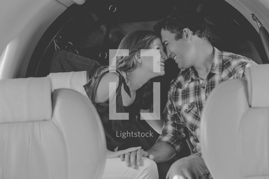 a couple sitting on a private plane 