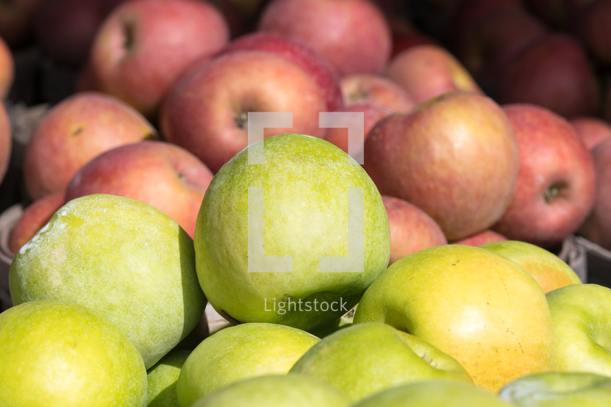 green and red apples in a basket 