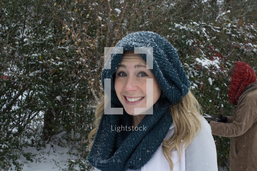 woman in a scarf standing outdoors in the snow 