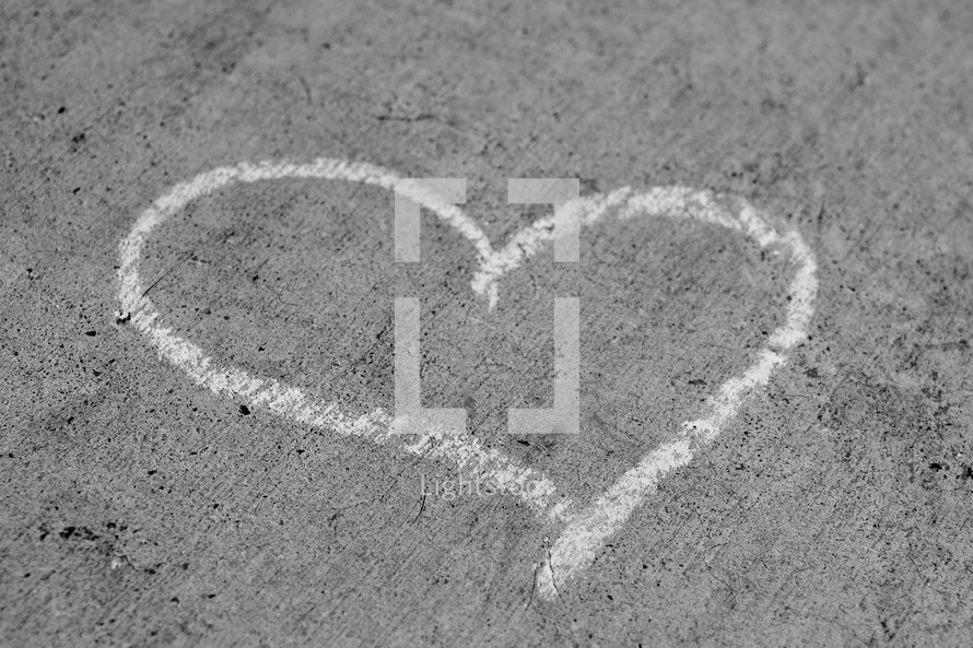 heart drawn in sidewalk chalk on concrete 
