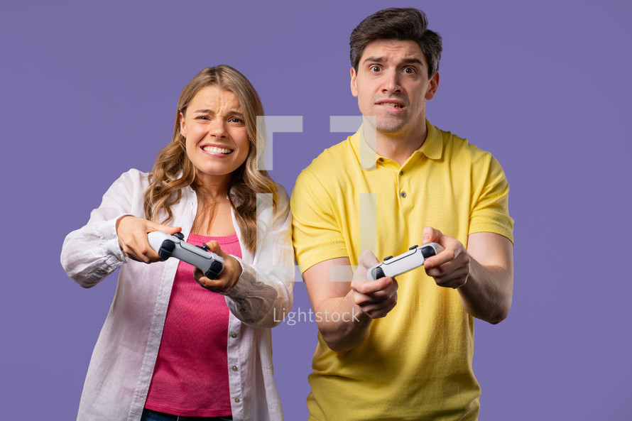 Gamer's couple playing online video game on console TV with joysticks, man win. Presses buttons, using joypad controller, newest wireless gamepad. Hobby, e-sport