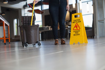a woman mopping a lobby 