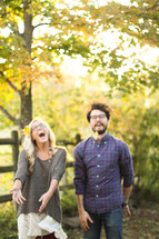 couple standing together laughing outdoors 