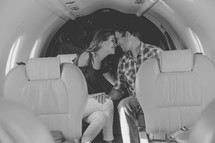 a couple sitting on a private plane