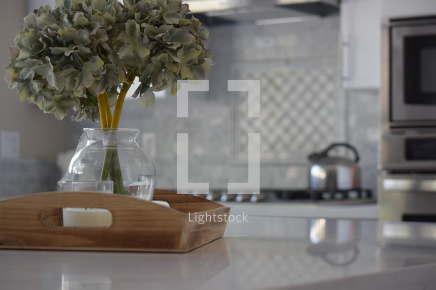 wooden tray on a quartz countertop in a kitchen 