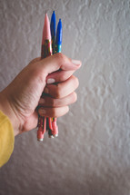 hand holding mechanical pencils and erasers 